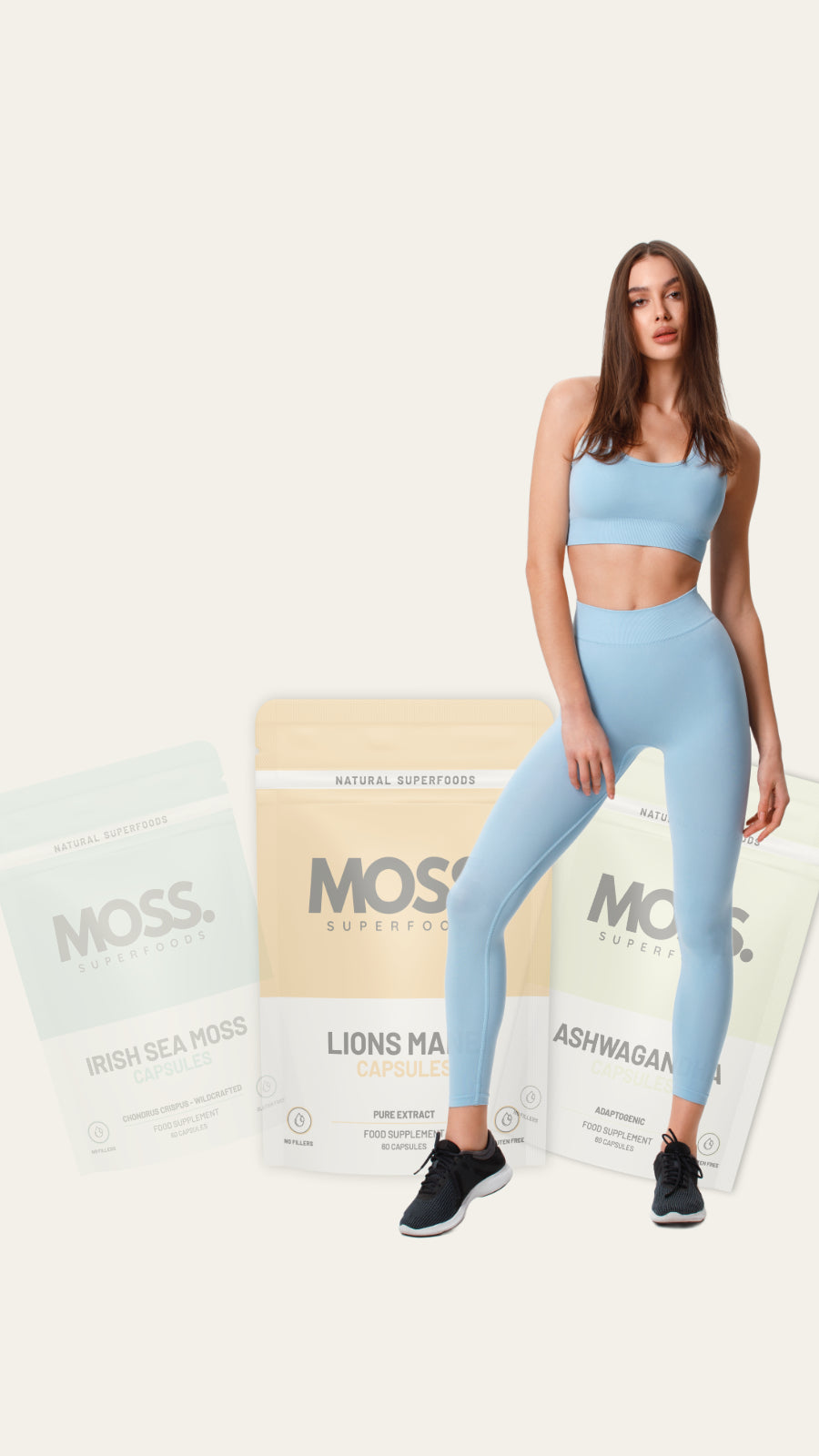 Moss Superfoods Women standing with seamoss capsules, lions mane and ashwagandha capsules